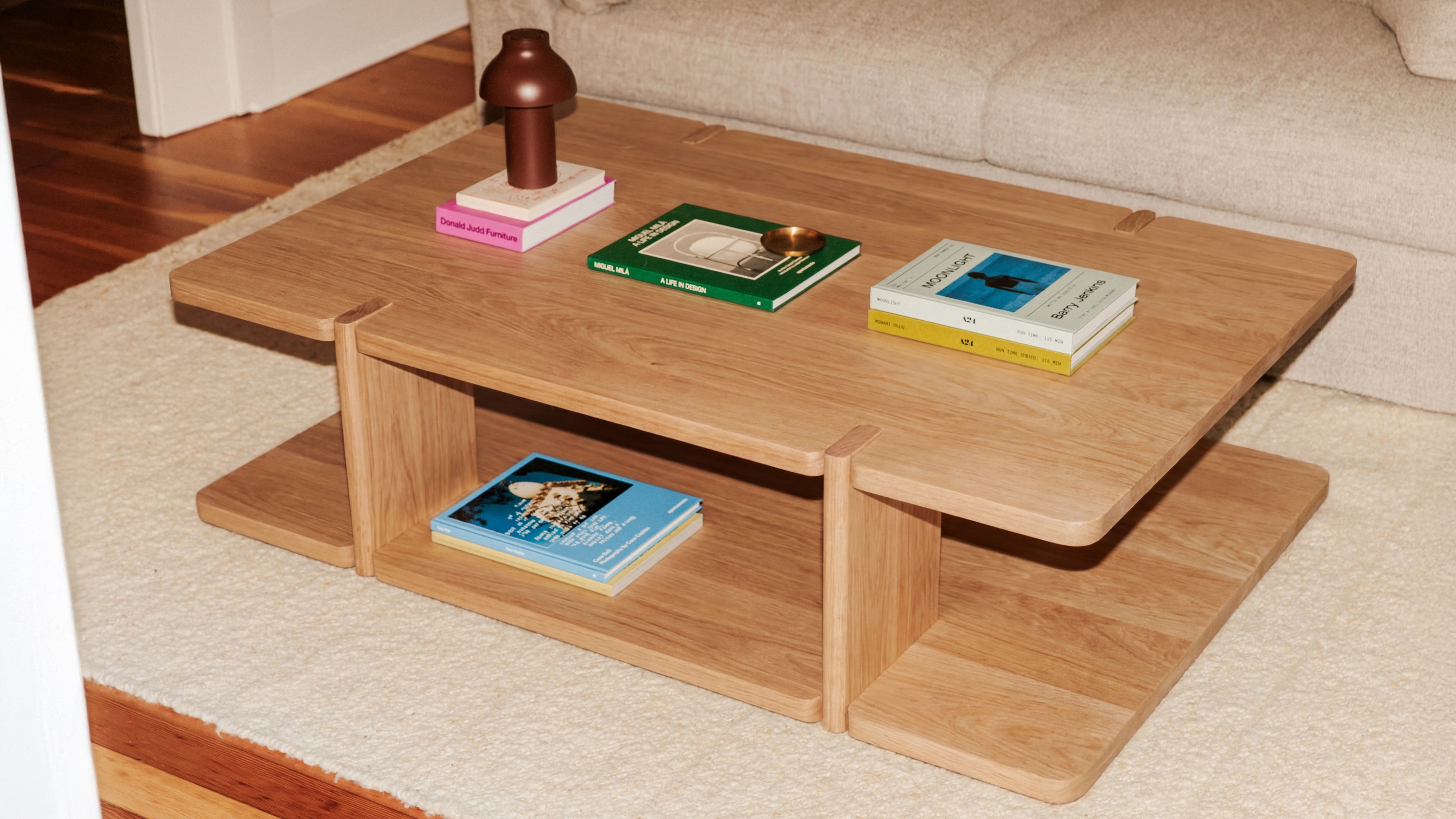 Wooden coffee table with books on a living room floor